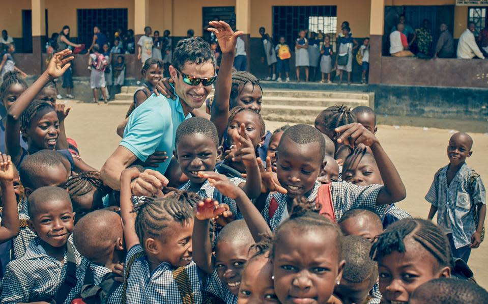 Alan Chorun with children in Sierra Leone, where his organization has built schools, hospitals and now a restaurant.
