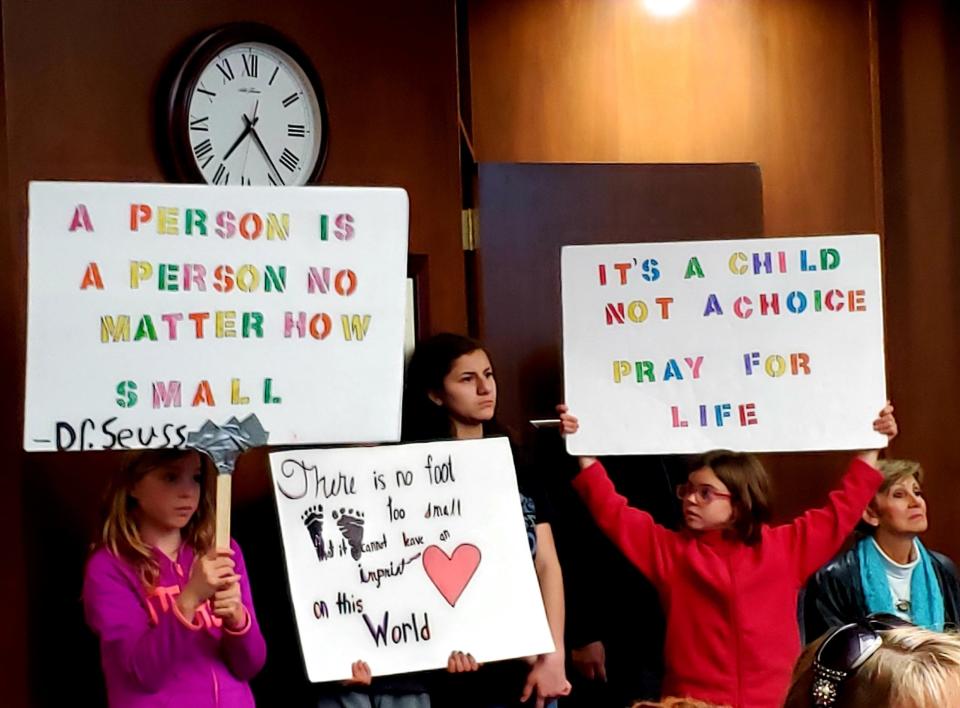 Children attending an Abilene City Council meeting hold signs supporting the idea of making Abilene a Sanctuary City for the Unborn at a January 2020 meeting. The idea is now gaining further traction with a petition to be examined by the council next week.