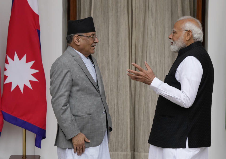Nepal’s Prime Minister Pushpa Kamal Dahal and his Indian counterpart Narendra Modi, right, chat before their meeting in New Delhi, India, Thursday, June 1, 2023. Dahal arrived Wednesday on a state visit, his first trip abroad since taking power in December last year. (AP Photo/Manish Swarup)