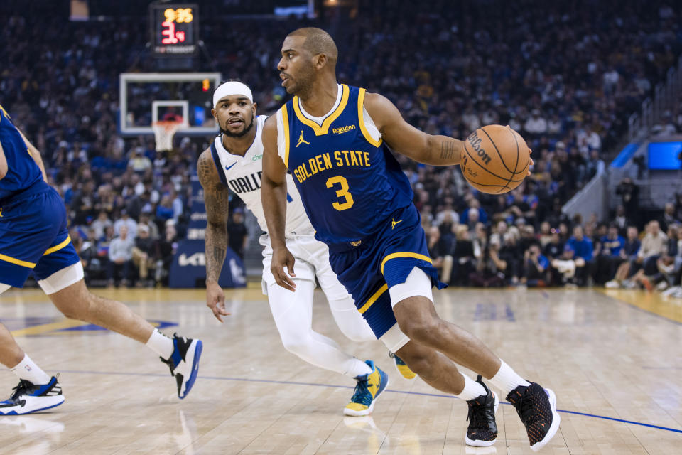 Golden State Warriors guard Chris Paul (3) drives past Dallas Mavericks guard Jaden Hardy during the first half of an NBA basketball game in San Francisco, Saturday, Dec. 30, 2023. (AP Photo/John Hefti)