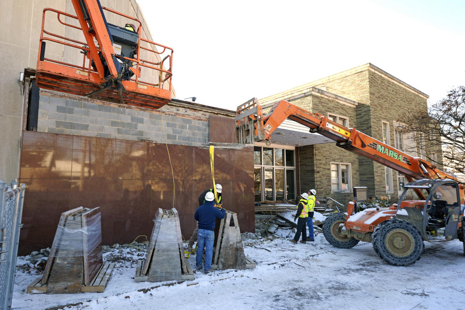 Workers begin demolition Wednesday, Jan. 17, 2023, at the Tree of Life building in Pittsburgh, the site of the deadliest antisemitic attack in U.S. history, as part of the effort to reimagine the building to honor the 11 people who were killed there in 2018. The demolition work began slowly, with crews picking away at the building's exterior. The new building will include spaces for worship and a museum, and will house community activities and programming about antisemitism. (AP Photo/Gene J. Puskar)