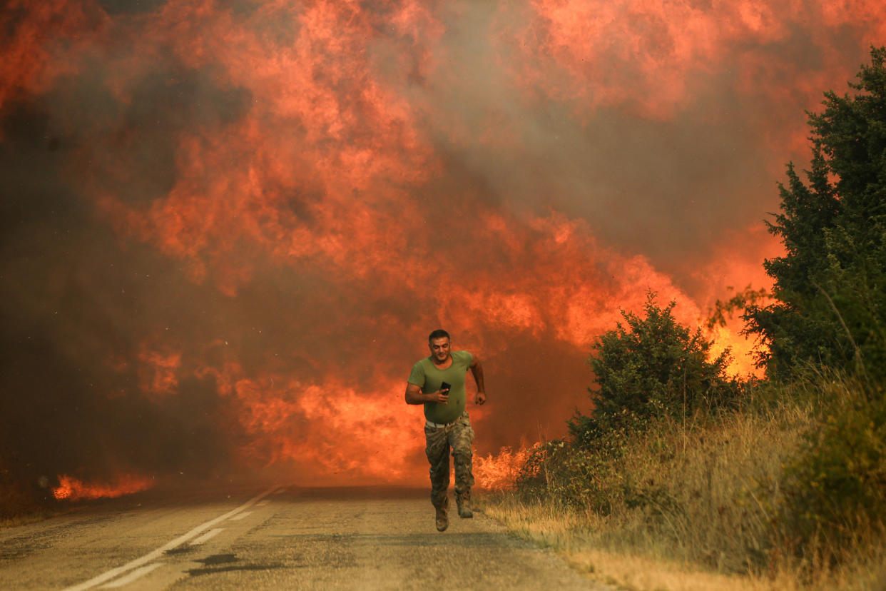 A firefighter runs as wildfire intensifies in Evros, Greece, on Aug. 31, 2023. (Ayhan Mehmet / Anadolu Agency via Getty Images file)