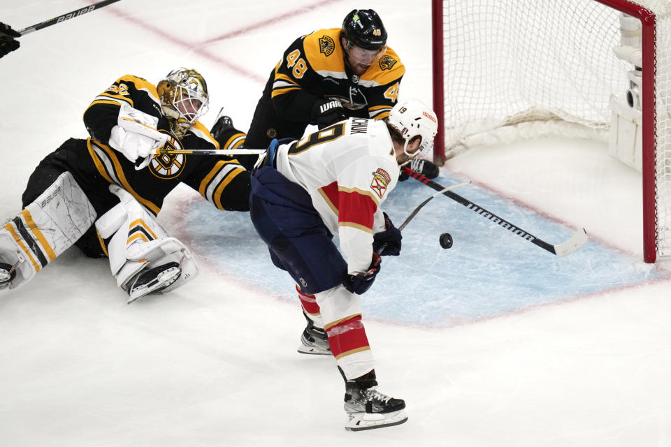 Florida Panthers left wing Matthew Tkachuk (19) shoots the puck past Boston Bruins goaltender Linus Ullmark and defenseman Matt Grzelcyk (48) while scoring the game-winning goal during overtime of Game 5 in the first round of the NHL hockey playoffs, Wednesday, April 26, 2023, in Boston. (AP Photo/Charles Krupa)