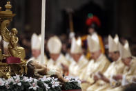 A statue of baby Jesus is laid on an altar during the Christmas Eve Mass celebrated by Pope Francis in St. Peter's Basilica at the Vatican, Monday, Dec. 24, 2018. (AP Photo/Alessandra Tarantino)