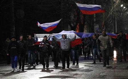 People march with Russian flags during a pro-Russian rally in Simferopol, Crimea February 27, 2014. REUTERS/David Mdzinarishvili