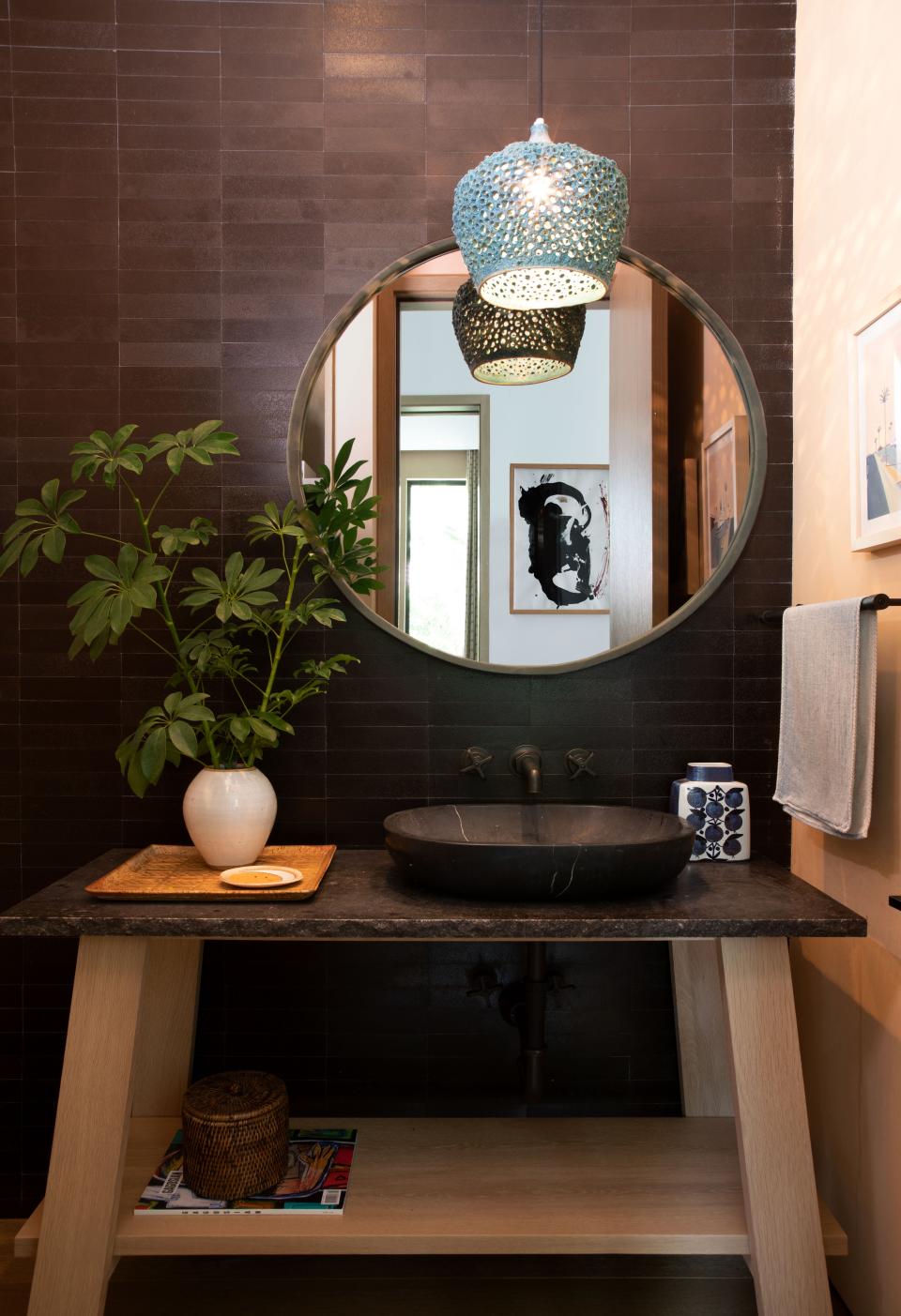 A 1960s Danish pendant from Atypical Find sets the powder room aglow.