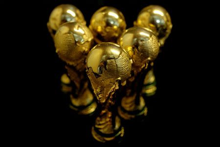 Scaled-down replicas of 2018 FIFA World Cup trophy are displayed at the showroom of a factory which manufactures official licensed products in Dongguan, China May 8, 2018. Picture taken May 8, 2018. REUTERS/Bobby Yip/File Photo/Files