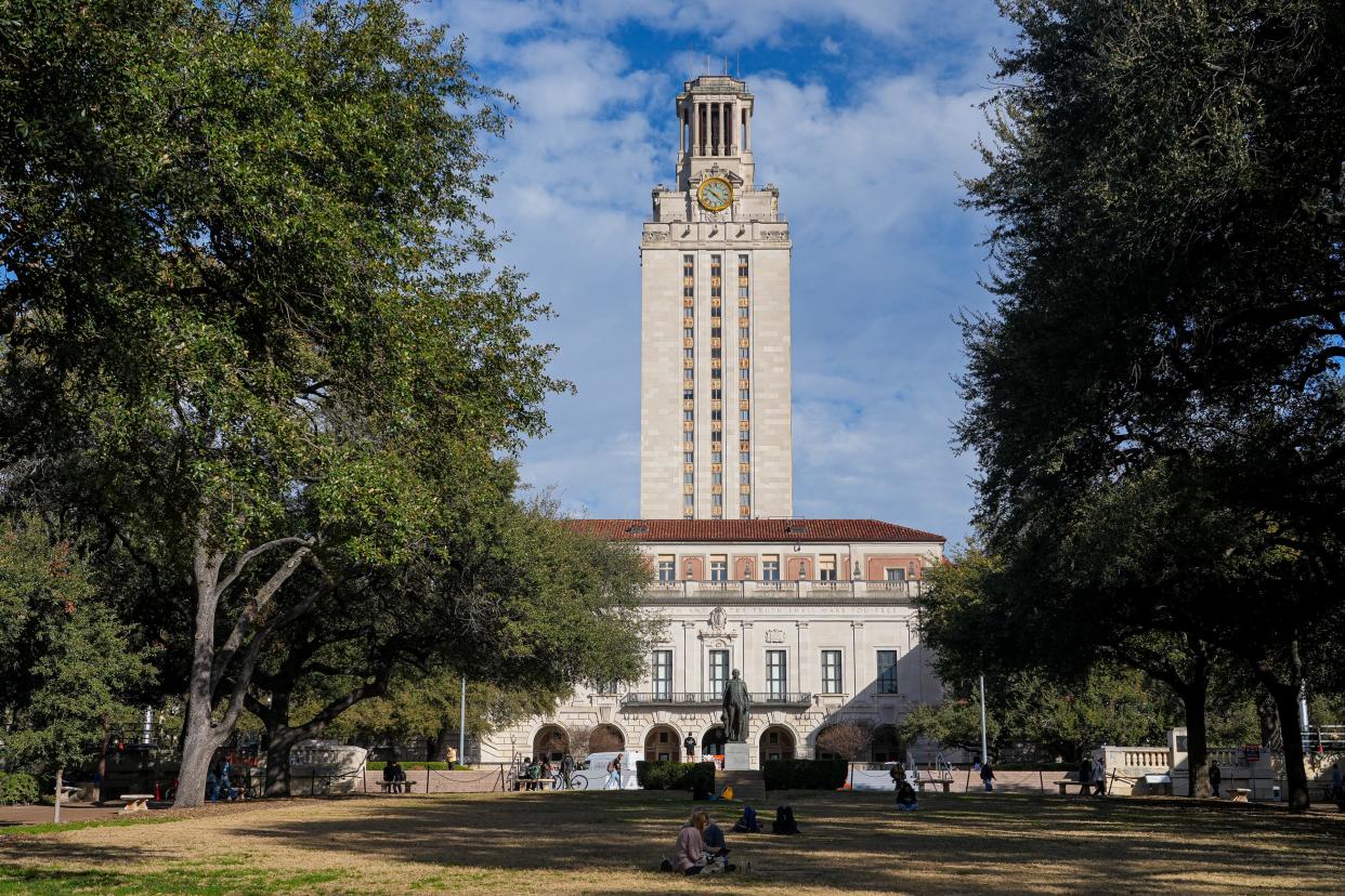 University of Texas students sit and lie in the grass in front of UT Tower on the first day of the spring semester on Jan. 9, 2023 in Austin. UT plans to establish a new School of Civic Leadership to teach students about "the values and principles of a free society" after the UT System Board of Regents' approved the proposal Thursday.