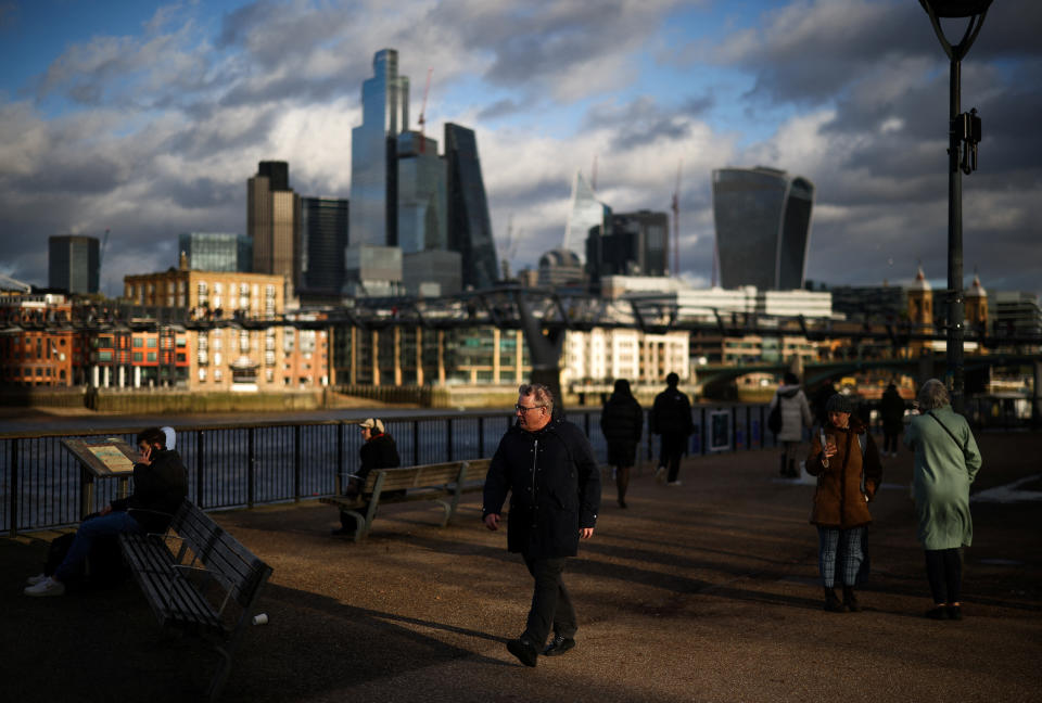 FTSE  People walk along the bank of the River Thames with the City of London financial district in the background, in London, Britain, January 13, 2023. REUTERS/Henry Nicholls