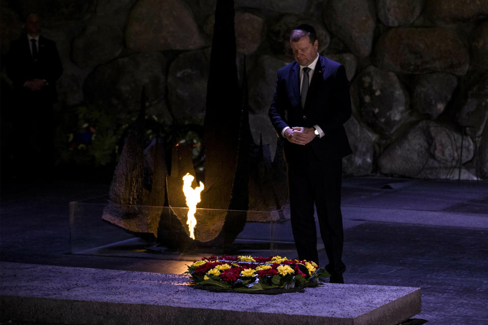 Lithuania's Prime Minister Saulius Skvernelis pays his respects at a ceremony at the Hall of Remembrance at the Yad Vashem Holocaust Memorial in Jerusalem, Tuesday Jan. 29, 2019. (AP Photo/Tsafrir Abayov)