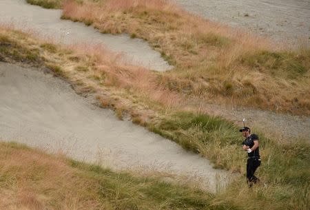 Dustin Johnson hits out of the rough on the 9th hole in the first round of the 2015 U.S. Open golf tournament at Chambers Bay. Mandatory Credit: Kyle Terada-USA TODAY Sports