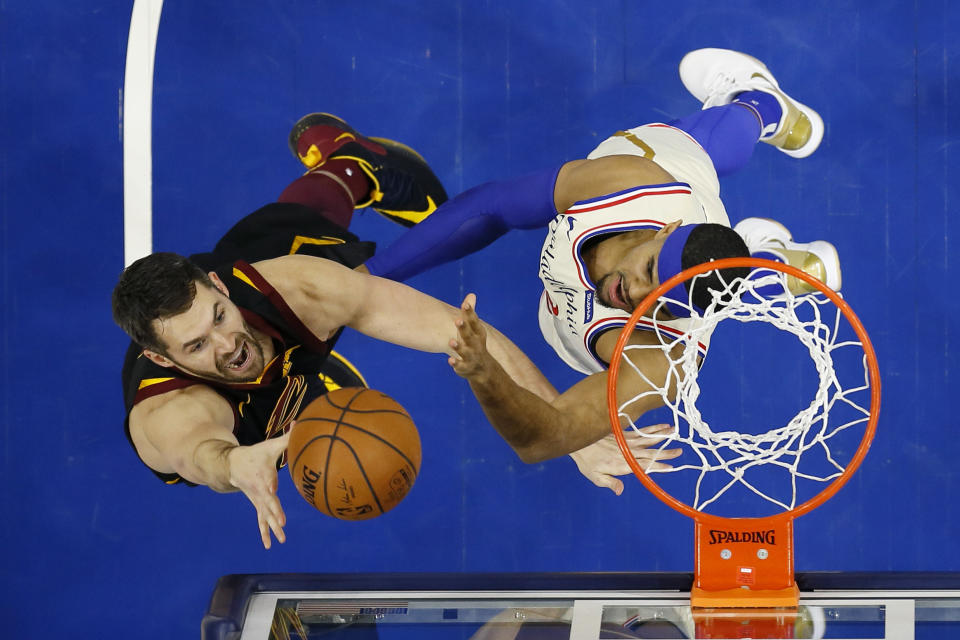 FILE - In this Dec. 7, 2019, file photo, Cleveland Cavaliers' Kevin Love, left, goes up to shoot against Philadelphia 76ers' Tobias Harris during the first half of an NBA basketball game, Saturday, Dec. 7, 2019, in Philadelphia. The NBA's decision to only invite 22 teams to resume play at Disney World in Florida next month was a body blow for players on the omitted squads _ aka the Delete 8. And although they have had time to process the exclusion, Sexton, Cavs star forward Love and their teammates, are still struggling with the reality that their season is over. (AP Photo/Matt Slocum, File)