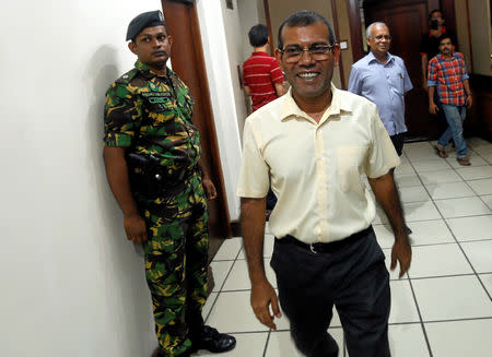 Maldives former President Mohamed Nasheed shares a moment as a Sri Lankan Special Task Force soldier stands guard next to him at a hotel in Colombo, Sri Lanka September 24, 2018. REUTERS/Dinuka Liyanawatte