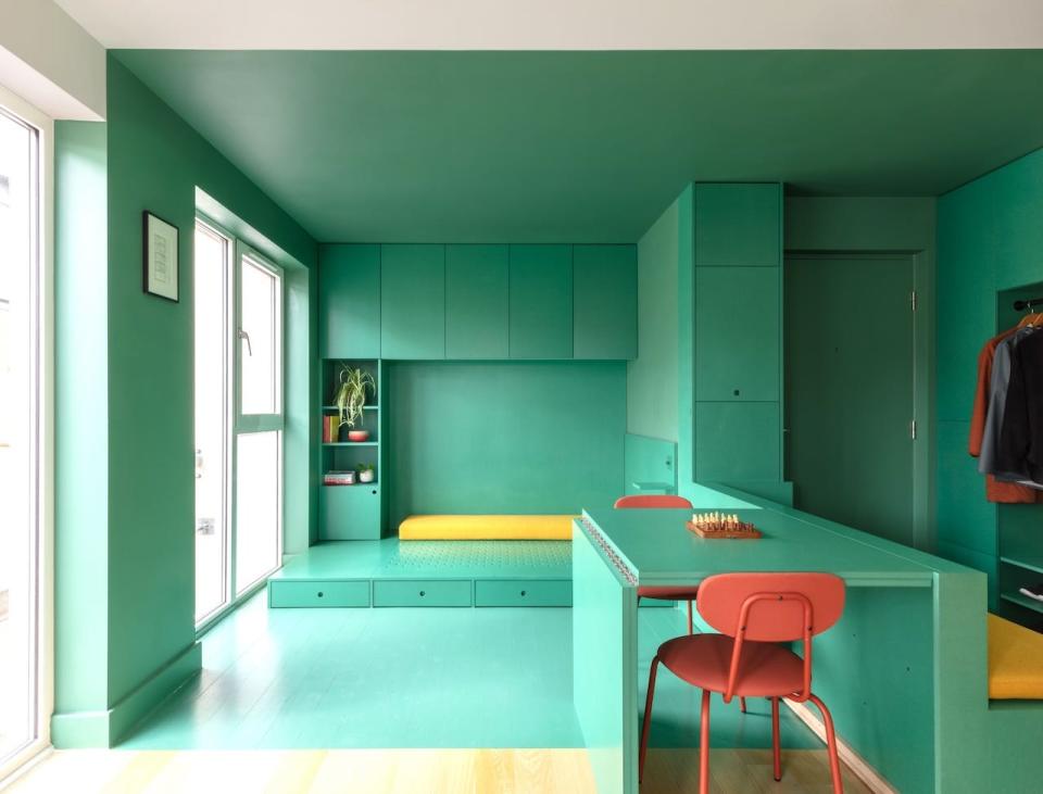 A green studio in London with a fold-out table and chairs.