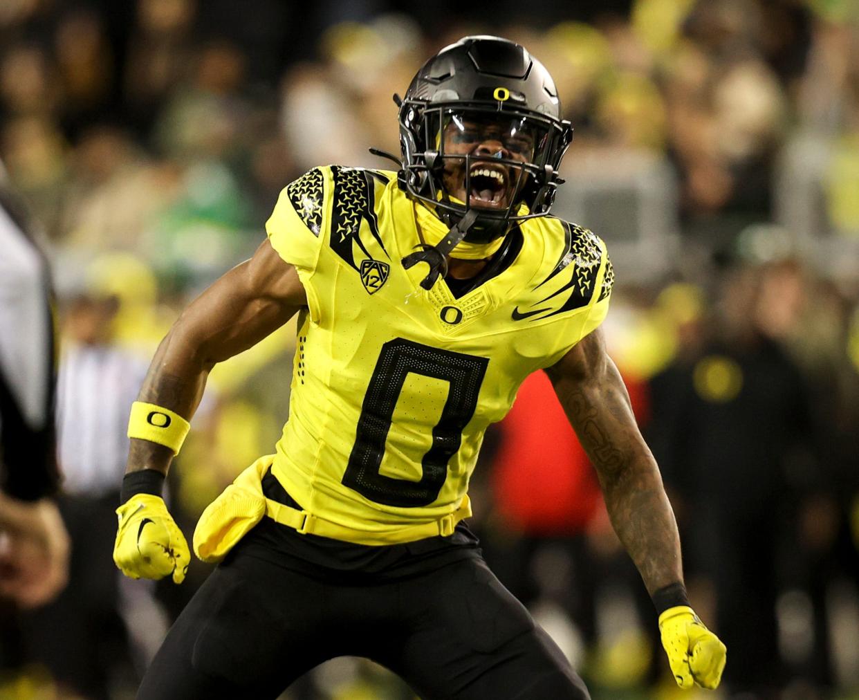 Oregon Ducks defensive back Tysheem Johnson (0) celebrates taking down USC Trojans wide receiver Zachariah Branch (1) during the second half of the game on Nov. 11 at Autzen Stadium in Eugene.