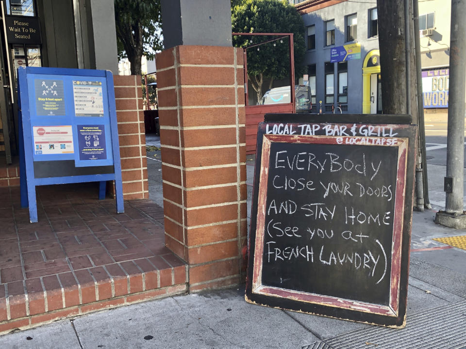 A sign calling out California Gov. Gavin Newsom for not following his own pandemic protocols at the French Laundry restaurant is seen in San Francisco on Dec. 8, 2020. A number of American political leaders have been caught preaching one thing on the coronavirus and doing another. Newsom, has fielded weeks of questions about whether he's a credible coronavirus messenger after dining out with a group. The Democrat has called it a lapse in judgment but has ignored questions about whether Californians can still trust him. (AP Photo/Juliet Williams)