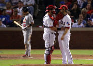 ARLINGTON, TX - OCTOBER 24: C.J. Wilson #36 and Mike Napoli #25 of the Texas Rangers talk on the mound during Game Five of the MLB World Series against the St. Louis Cardinals at Rangers Ballpark in Arlington on October 24, 2011 in Arlington, Texas. (Photo by Doug Pensinger/Getty Images)