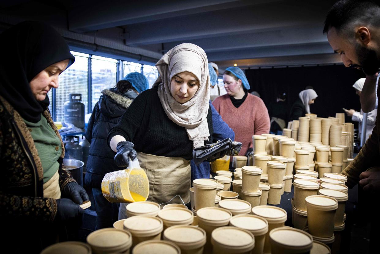 People prepare food for Iftar, the fast-breaking meal eaten by Muslims at sundown during the holy month of Ramadan, at a parking lot in Osdorp neighbourhood, on April 14, 2023.