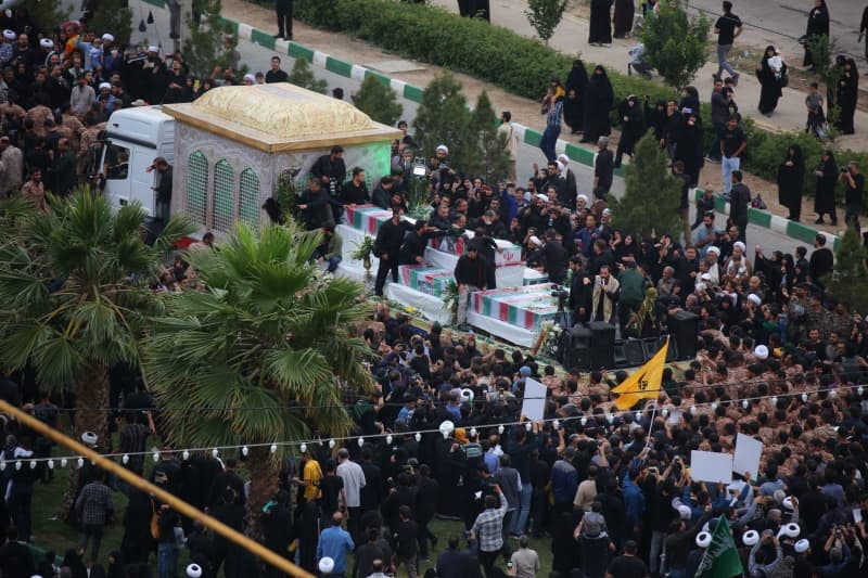 People attend a funeral procession for the late Iranian President Ebrahim Raisi, Foreign Minister Hossein Amirabdollahian and six other passengers and crew who died in a helicopter crash on a mist-shrouded mountainside in the northwest.  Ahmad Zohrabi/dpa
