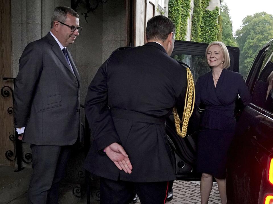 Newly elected leader of the Conservative party Liz Truss is greeted by Queen Elizabeth II's Equerry Lieutenant Colonel Tom White and her Private Secretary Sir Edward Young as she arrives at Balmoral for an audience with Queen Elizabeth II