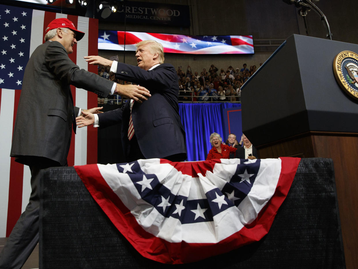 The President hugs US Senate candidate Luther Strange during a campaign rally: AP