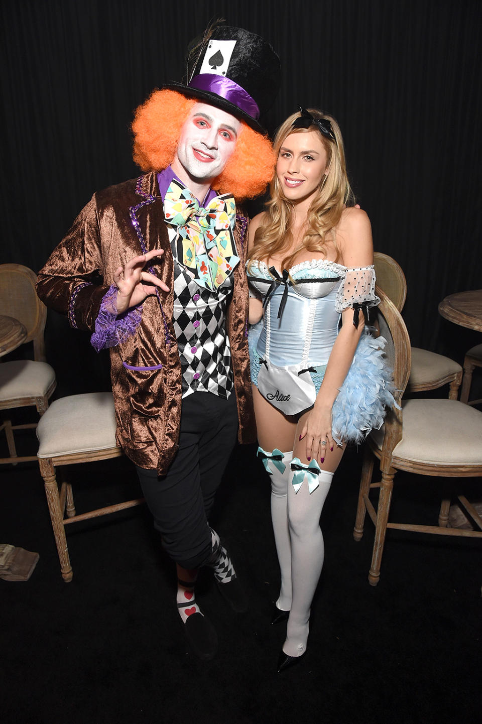 <p>The Olympic swimmer got all decked out as the Mad Hatter, while his fiancée, Kayla Rae Reid, naturally went as a sexy Alice in Wonderland. How original! (Photo: Michael Kovac/Getty Images) Tequila) </p>