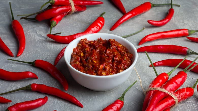 harissa and peppers on table