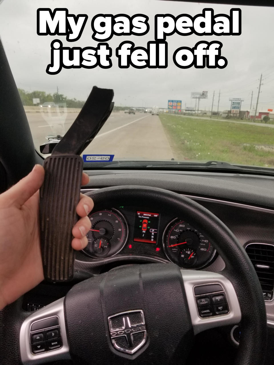 "My gas pedal just fell off": A person holding up a gas pedal in the driver's seat