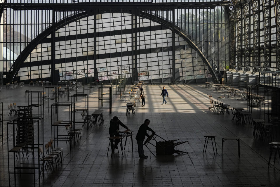 Electoral workers prepare the old Mapocho train station, now a cultural center, to be a polling station for the Constitutional Council election in Santiago, Chile, Friday, May 5, 2023. The election will be held May 7, after a first attempt to replace the current Constitution bequeathed by the military 42 years ago was rejected by voters in 2022. (AP Photo/Esteban Felix)