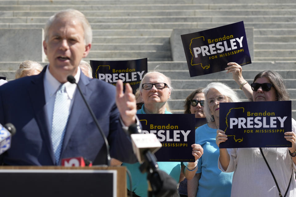 Supporters of Northern District Public Service Commissioner Brandon Presley, a candidate for the Democratic nomination for governor, wave signs during his news conference Tuesday, May 16, 2023, at the Mississippi Capitol in Jackson, Miss. (AP Photo/Rogelio V. Solis)