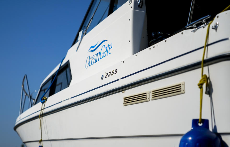A boat with the OceanGate logo is parked on a lot near the OceanGate offices Thursday, June 22, 2023, in Everett, Wash. The U.S. Coast Guard said Thursday that the missing submersible Titan imploded near the Titanic shipwreck site, killing everyone on board. (AP Photo/Lindsey Wasson)
