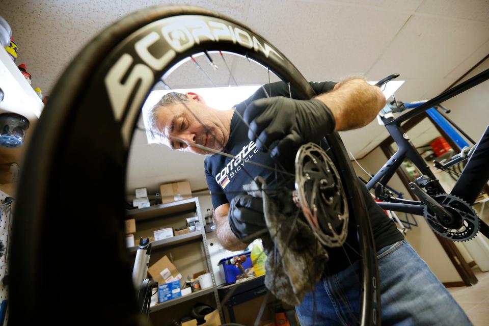 Tony Branco, owner of Scorpion Bike Wheels, puts the finishing touches on a set of carbon wheels he built for a customer, before installing them on the frame he is building seen in the background. Branco started building high performance bicycle wheels in his basement and has now opened his own shop in the Jack Conway plaza on Route 6 in Dartmouth.
