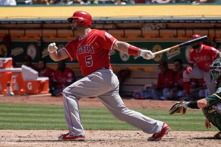 Jun 16, 2018; Oakland, CA, USA; Los Angeles Angels first baseman Albert Pujols (5) hits a single against the Oakland Athletics during the fifth inning at the Oakland Coliseum. Mandatory Credit: Stan Szeto-USA TODAY Sports