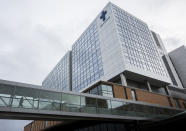 A person walks across the skybridge at Providence Regional Medical Center Everett where a man with the first case of coronavirus in the United States is being treated on Tuesday, Jan. 21, 2020, in Everett, Wash. A U.S. resident who recently returned from a trip to central China has been diagnosed with the new virus. Health officials said Tuesday that the man returned to the Seattle area in the middle of last week after traveling to the Wuhan area, where the outbreak began. (Olivia Vanni/The Herald via AP)