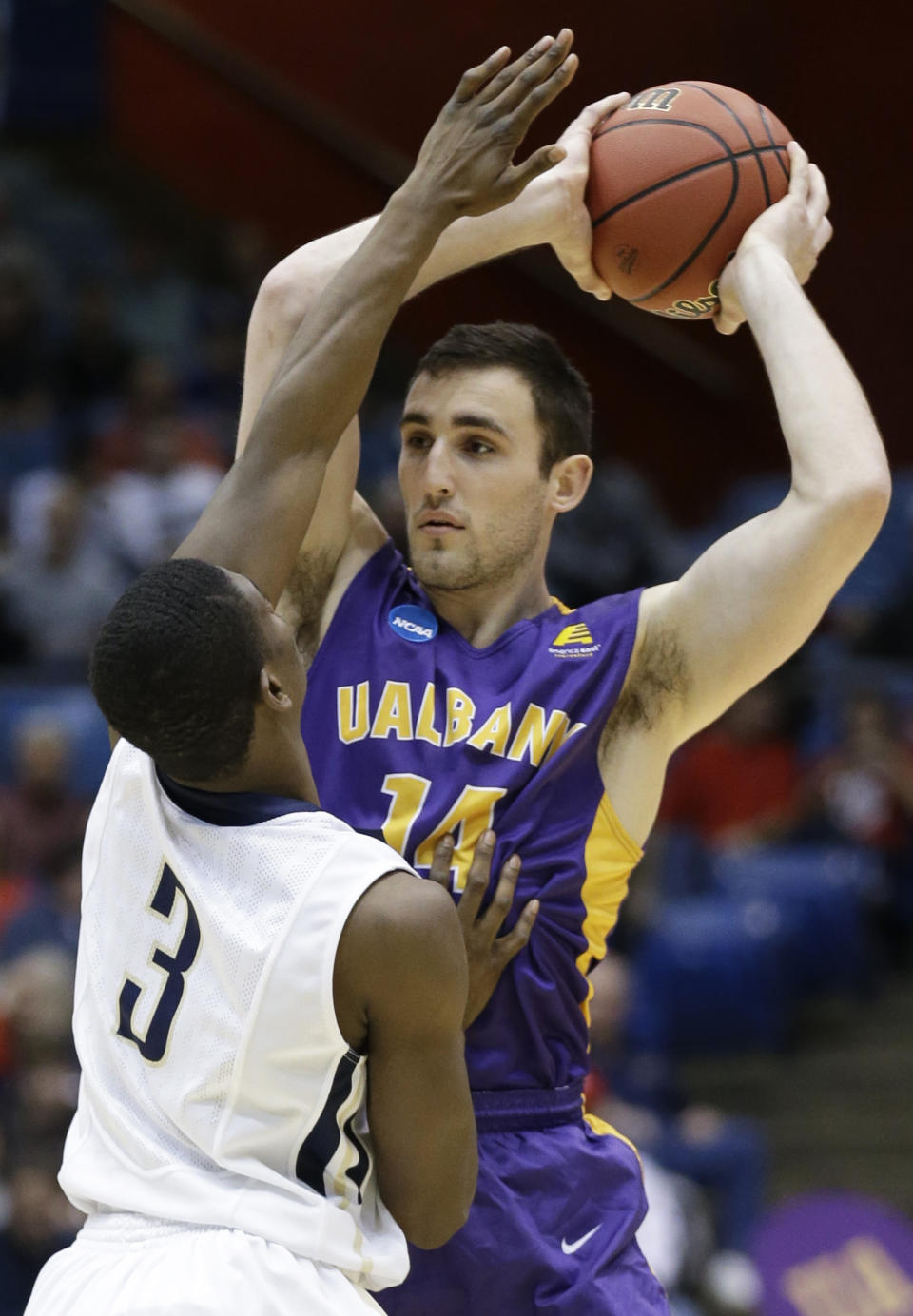 Albany forward Sam Rowley (14) is pressured by Mount St. Mary's guard Sam Prescott (3) in the first half of a first-round game of the NCAA college basketball tournament, Tuesday, March 18, 2014, in Dayton, Ohio. (AP Photo/Al Behrman)