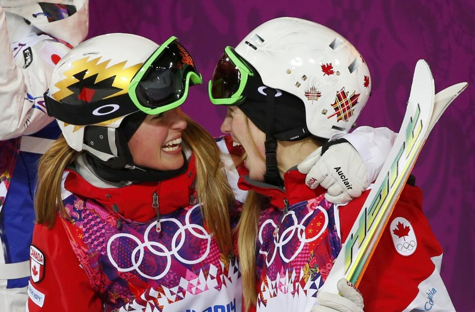 Second-placed Chloe Dufour-Lapointe of Canada congratulates her sister, winner Justine Dufour-Lapointe, after the women's freestyle skiing moguls final competition at the 2014 Sochi Winter Olympic Games in Rosa Khutor