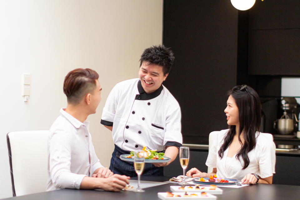 A private chef giving a couple their dinner