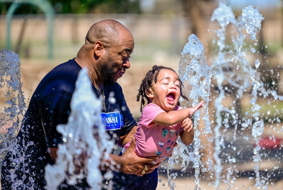 Robert Taylor plays with his daughter Lennox Taylor, 1, Tuesday, September 6, 2022 in the splash pad at Riverway Sports Park.