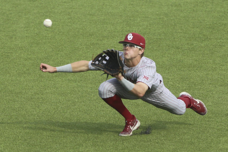 Oklahoma's John Spikerman (8) catches a fly ball in right field for the final out against Virginia Tech during an NCAA college baseball tournament super regional game Friday, June 10, 2022, Blacksburg, Va. (AP Photo/Matt Gentry)