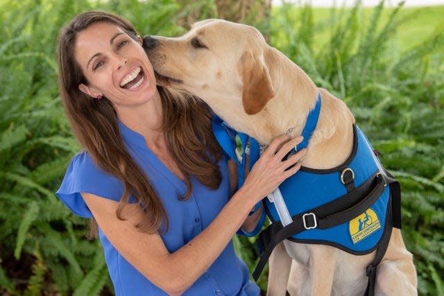 Melanie Lomaglio with facility dog Harley, who was trained by Canine Companions for Independence.