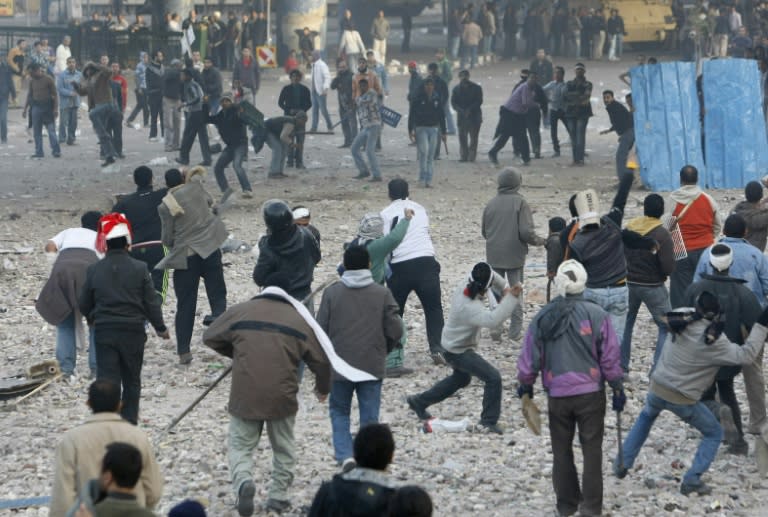 Egyptian anti-government demonstrators (bottom) clash with pro-regime supporters in Cairo’s Tahrir Square during the 2011 revolt that deposed Hosni Mubarak