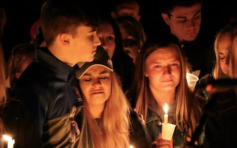 People attend a vigil for the victims of a fatal shooting at Marshall County High School  - Credit: Robert Ray/AP