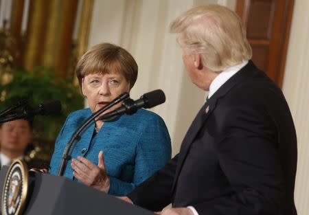 Germany's Chancellor Angela Merkel speaks as U.S. President Donald Trump looks on during their joint news conference in the East Room of the White House in Washington, U.S., March 17, 2017. REUTERS/Jonathan Ernst