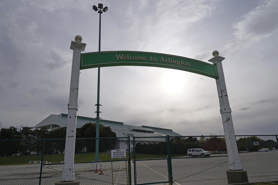 A welcome sign stands outside the shuttered Arlington International Racecourse in Arlington Heights, Ill., Friday, Oct. 14, 2022. The Chicago Bears want to turn the Arlington Heights site, once a jewel of thoroughbred racing, into a different kind of gem, anchored by an enclosed stadium and bursting with year-round activity — assuming a deal with Churchill Downs Inc. to buy the land goes through. (AP Photo/Nam Y. Huh)