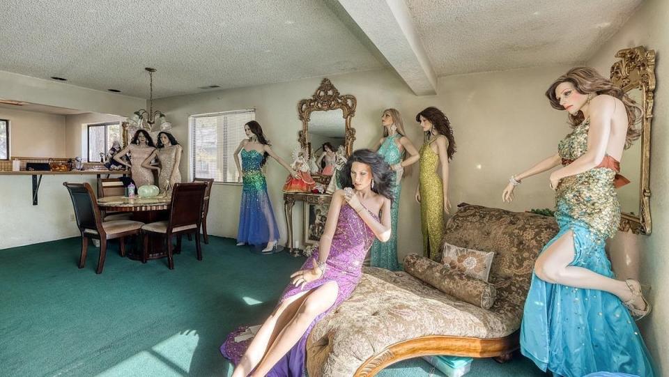 Living room full of female mannequins in ball gowns