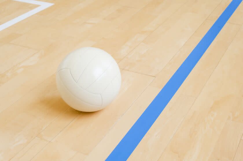 Volleyball ball on hardwood volleyball court