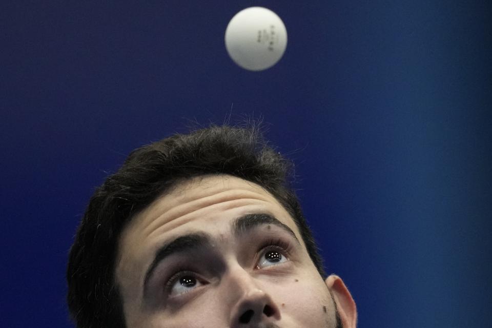 Puerto Rico's Brian Afanador competes in the men's table tennis singles final round against Cuba's Andy Pereira at the Central American and Caribbean Games in San Salvador, El Salvador, Tuesday, June 27, 2023. (AP Photo/Arnulfo Franco)