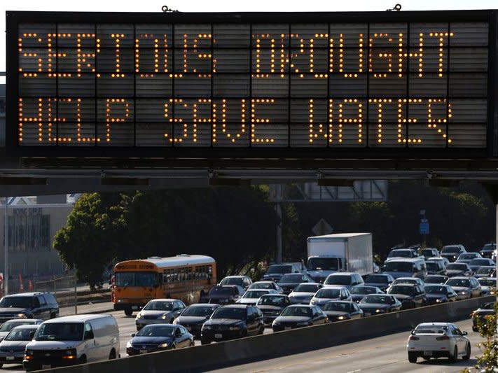 A Caltrans information sign urges drivers to save water due to the California drought emergency in Los Angeles, California in this February 13, 2014 file photo. REUTERS/Jonathan Alcorn/Files