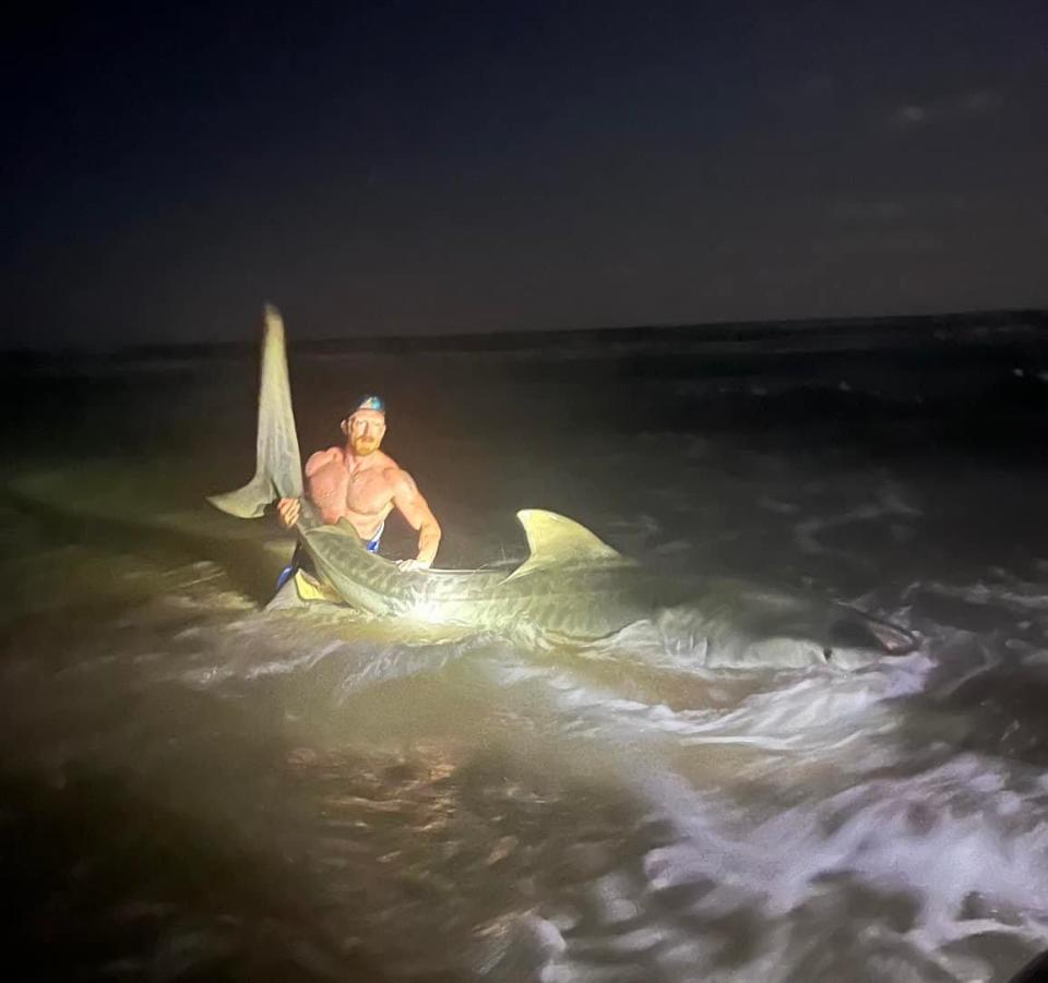 Christian Haltermann reeled in a 12.5-foot tiger shark while fishing at the Padre Island National Seashore with his son in May 2022.