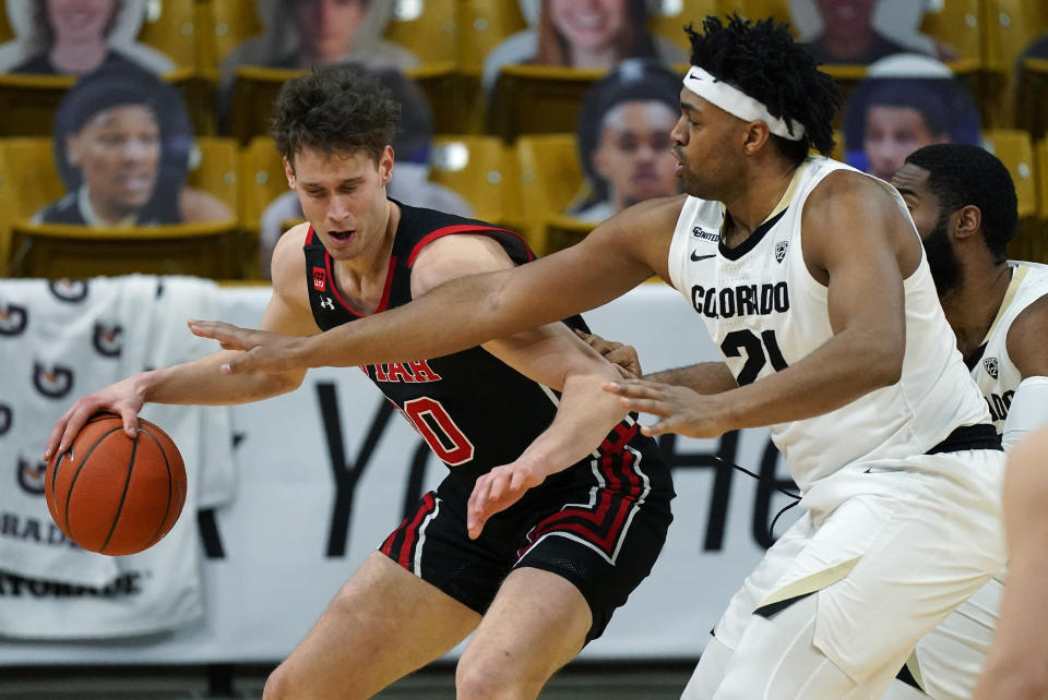 Utah forward Mikael Jantunen, left, drives to the basket as Colorado forward Evan Battey defends in the second half of an NCAA college basketball game Saturday, Jan. 30, 2021, in Boulder, Colo. (AP Photo/David Zalubowski)